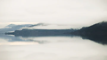 A large body of water surrounded by mountains